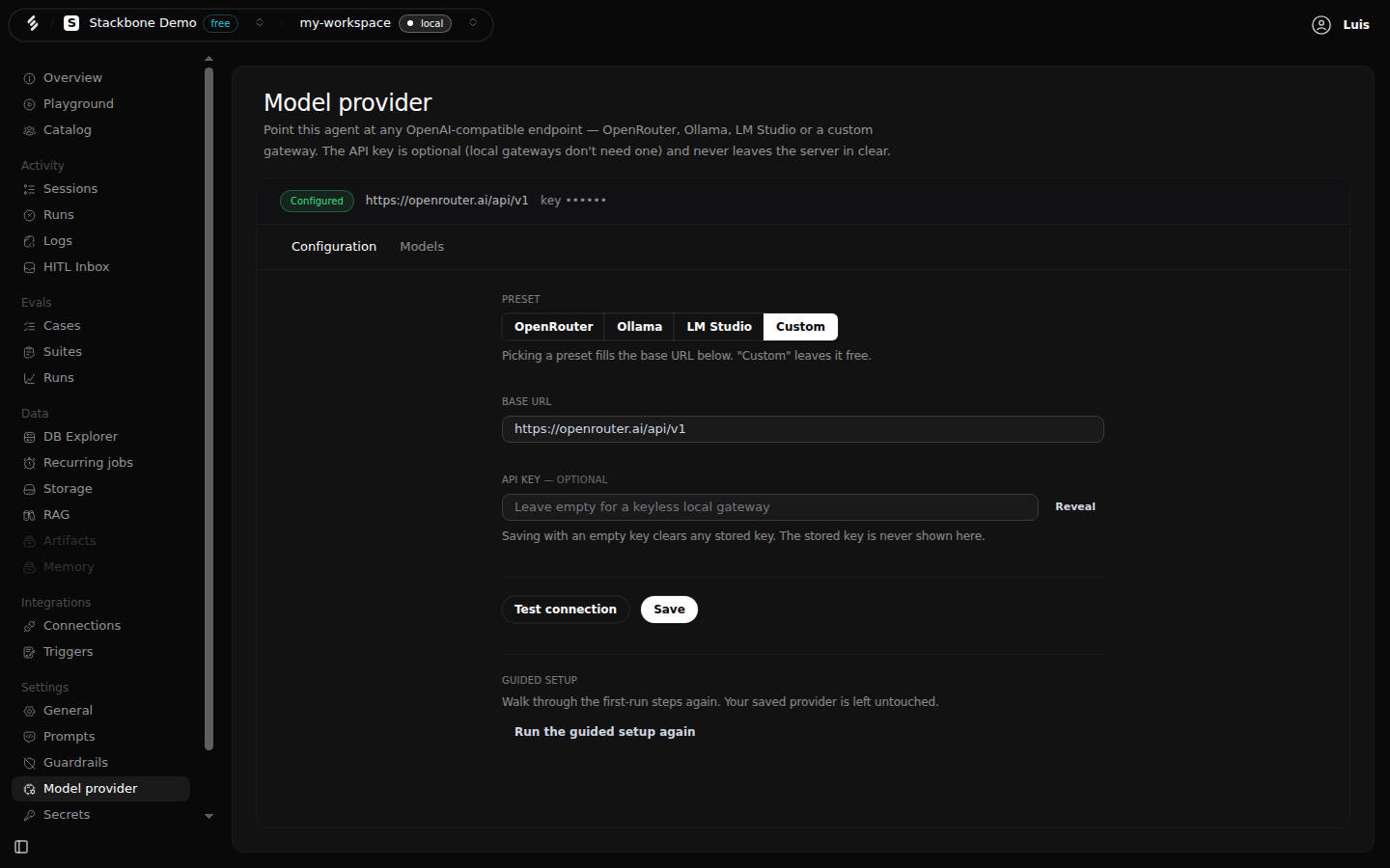 The Model provider screen in Studio: the OpenRouter preset selected, the base URL, an empty API key field with a Reveal button, the note 